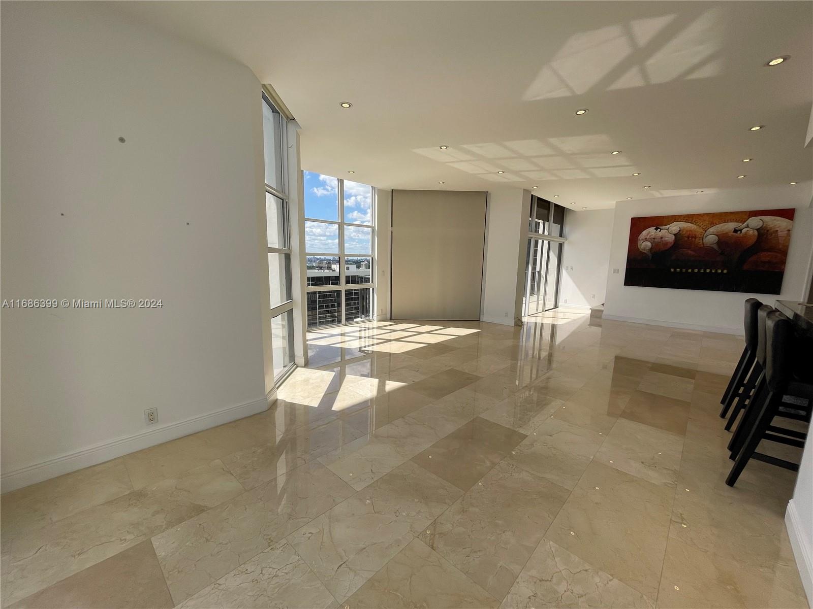 1865 Brickell Avenue, Unit APH6 Miami, FL 33129 - Photo 4 of 24 a view of livingroom with furniture and windows