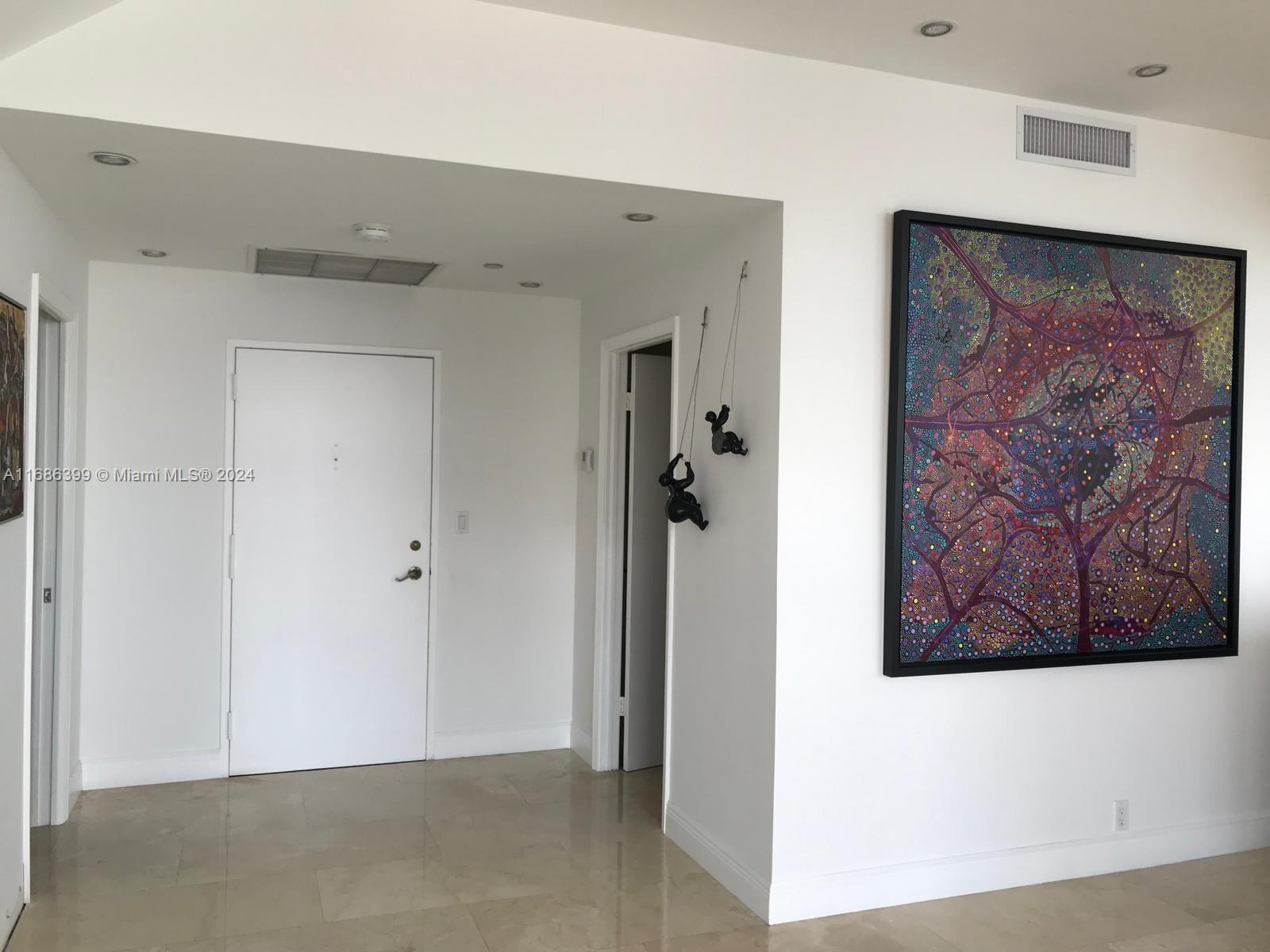 1865 Brickell Avenue, Unit APH6 Miami, FL 33129 - Photo 5 of 24 a view of a hallway with paintings on the wall