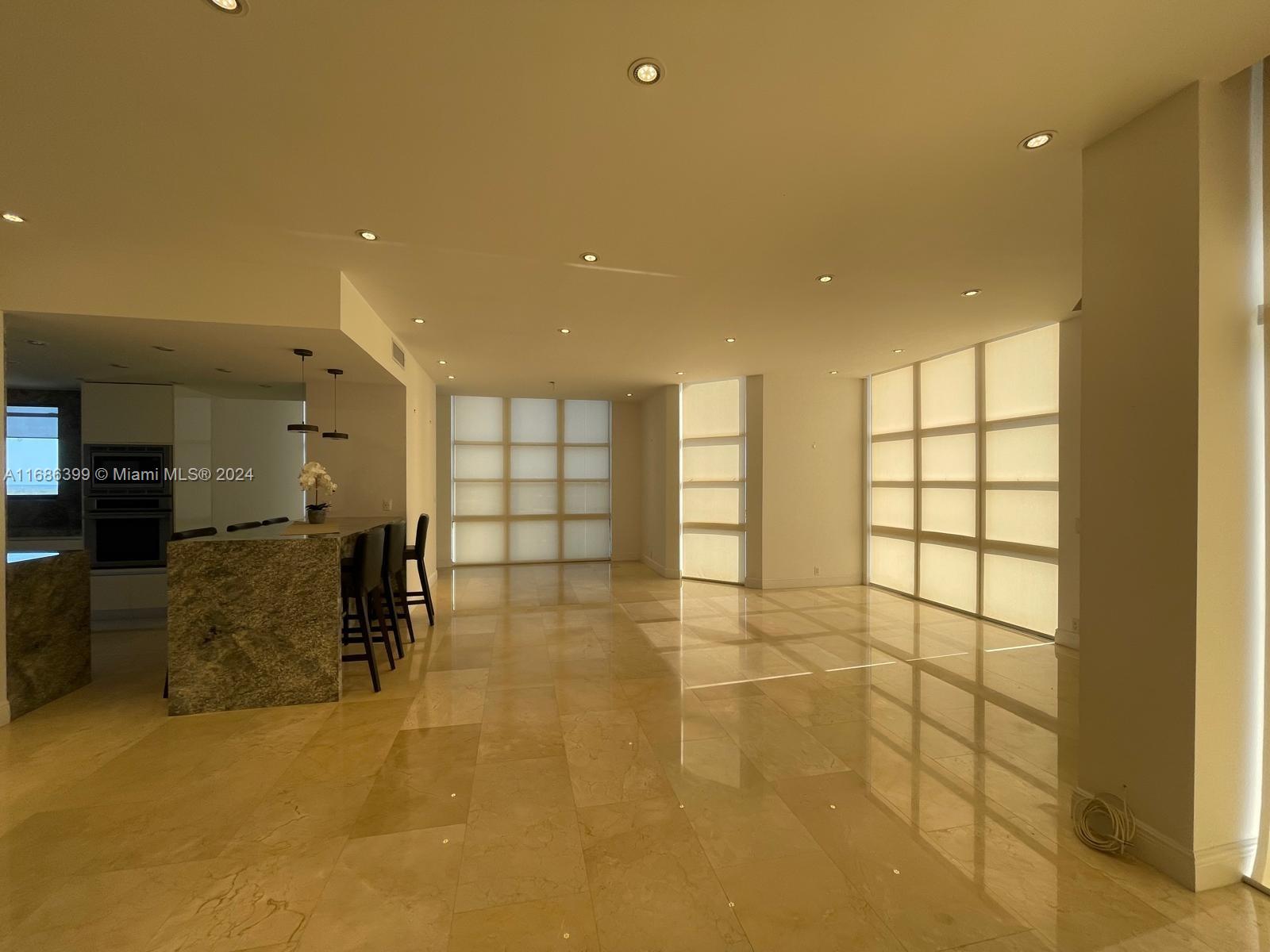 1865 Brickell Avenue, Unit APH6 Miami, FL 33129 - Photo 6 of 24 a view of a livingroom with furniture and a window