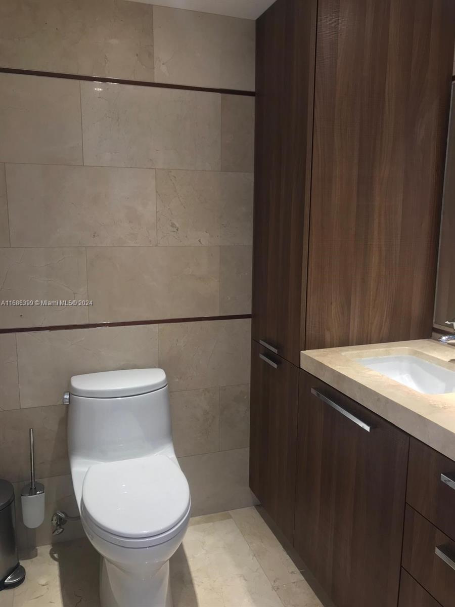 1865 Brickell Avenue, Unit APH6 Miami, FL 33129 - Photo 8 of 24 a bathroom with a toilet and a sink