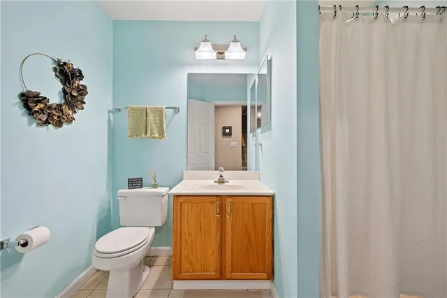 a bathroom with a toilet sink and mirror