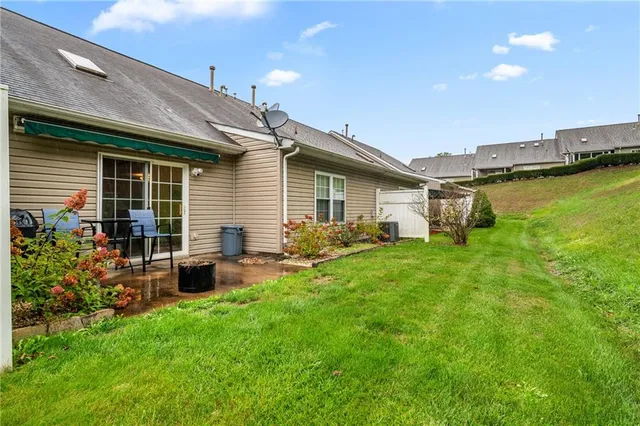 a front view of house with yard and outdoor seating