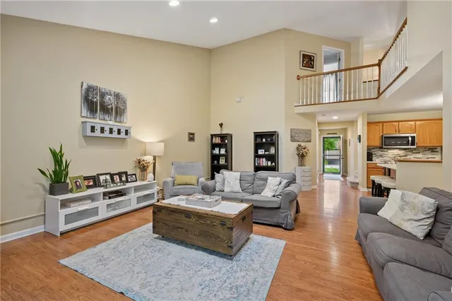 a living room with furniture wooden floor and a rug
