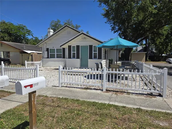 a front view of a house with wooden fence