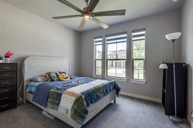 a bedroom with a bed next to a window