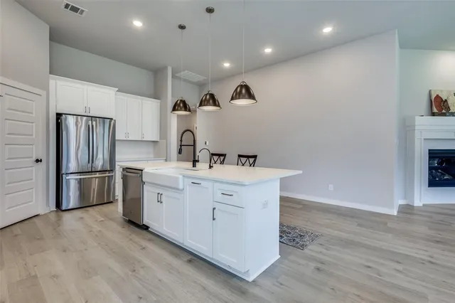a kitchen with a sink stainless steel appliances and cabinets