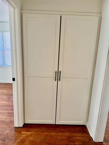 a view of a room with wooden floor