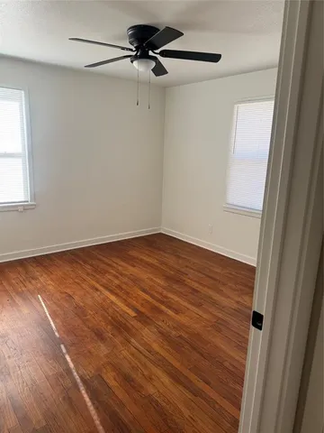 a view of room with wooden floor and fan