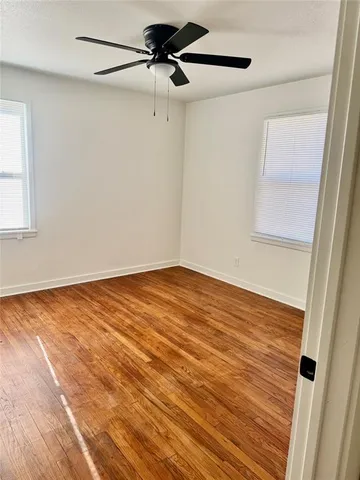 a view of a room with wooden floor and white walls