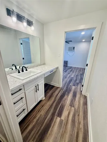 a bathroom with a sink mirror and vanity