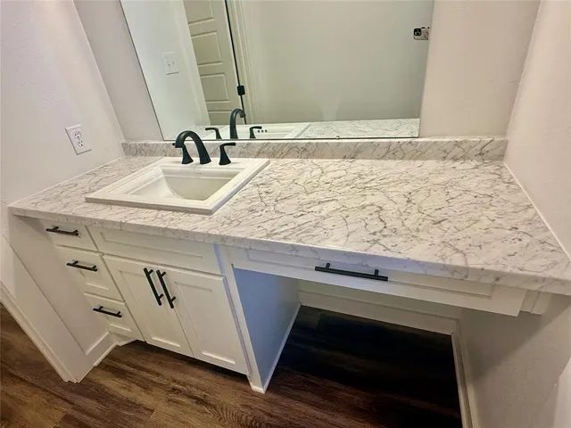 a bathroom with a sink and a mirror