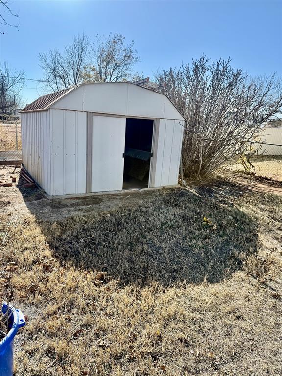 1541 McCarty Aspermont, TX 79502 - Photo 26 of 29 a house covered with wooden fence and trees