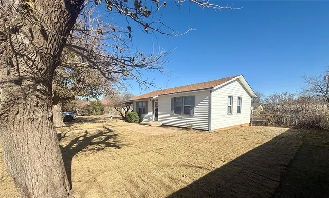 a view of a house with a yard covered in snow
