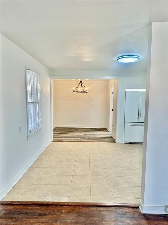1541 McCarty Aspermont, TX 79502 - Photo 5 of 29 a view of an empty room with wooden floor and a window