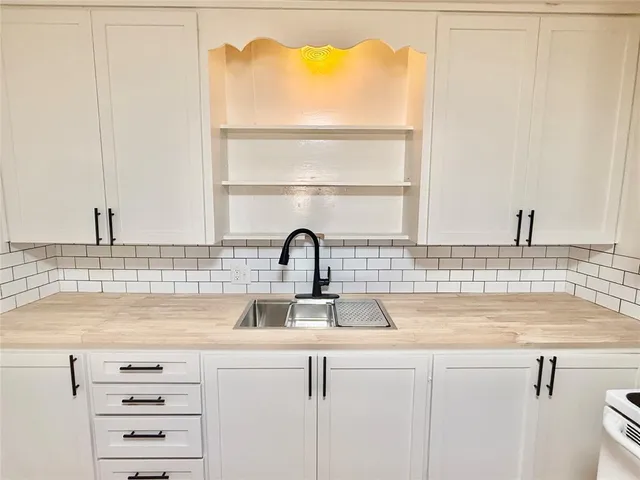 a kitchen with a sink and a window