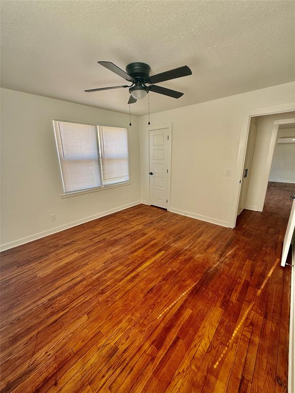 1541 McCarty Aspermont, TX 79502 - Photo 9 of 29 a view of empty room with wooden floor and fan