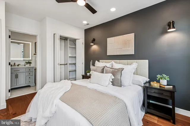 a bedroom with bed and cabinets