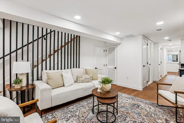 a living room with furniture and wooden floor