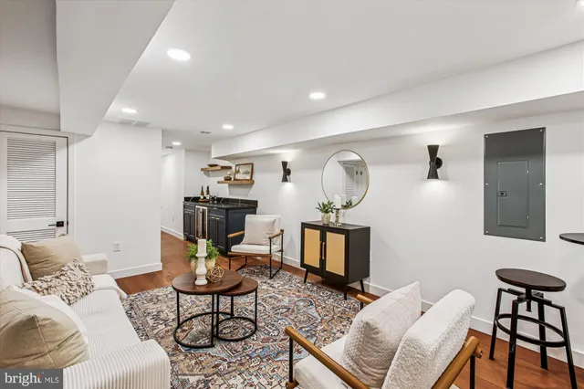 a living room with furniture and wooden floor