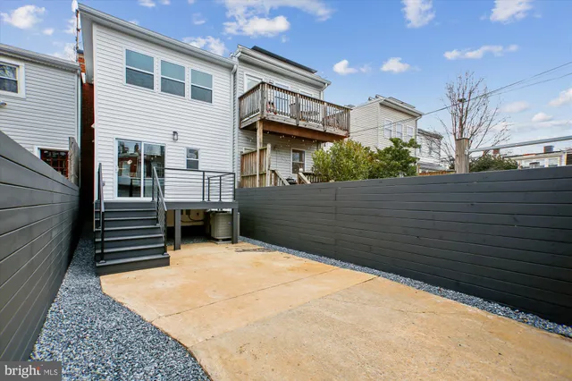 a view of house with roof deck and seating space