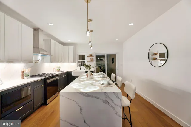 a large kitchen with stainless steel appliances granite countertop a stove a sink a refrigerator and a granite counter tops