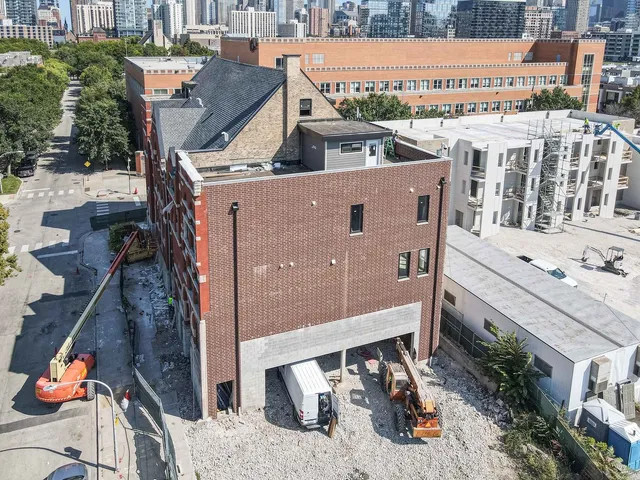 an aerial view of a house with a yard and balcony