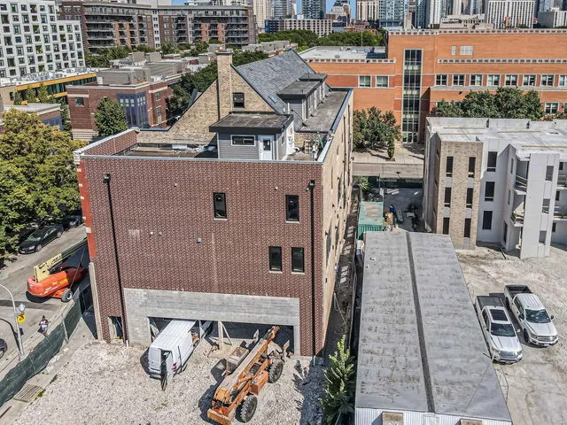 an aerial view of a house with garden space and street view