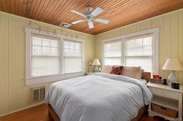 a bed sitting in a bedroom next to a window