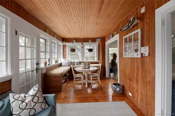 a dining room with furniture window and wooden floor