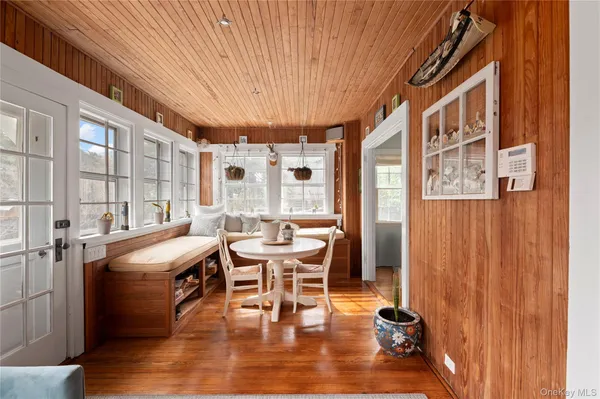 a dining room with a table chairs and entryway