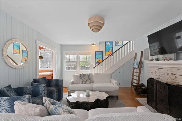 a living room with furniture a flat screen tv and a fireplace