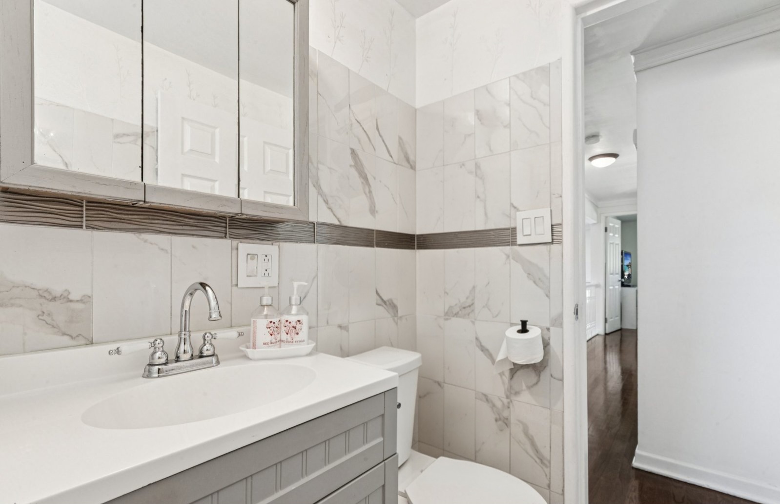122 West Helen Road Palatine, IL 60067 - Photo 17 of 58 a bathroom with a sink a toilet and a mirror