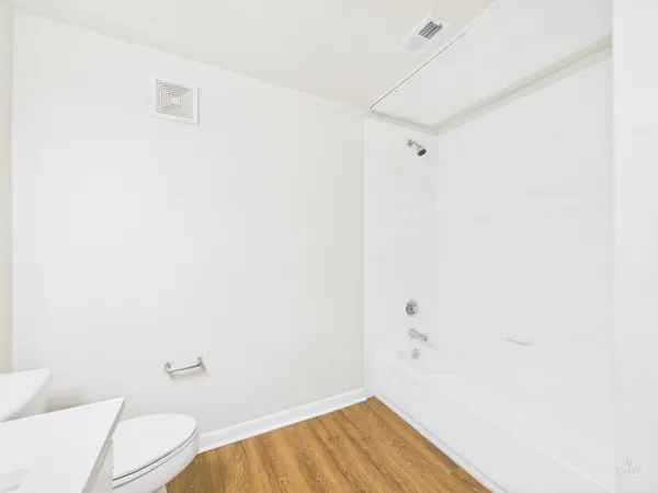 a view of a room with wooden floor