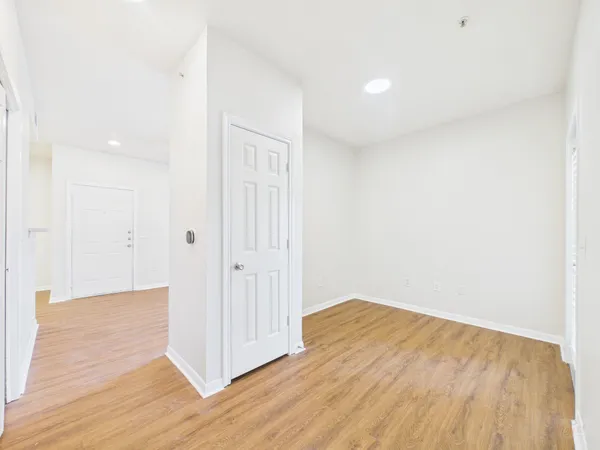 a view of a room with wooden floor