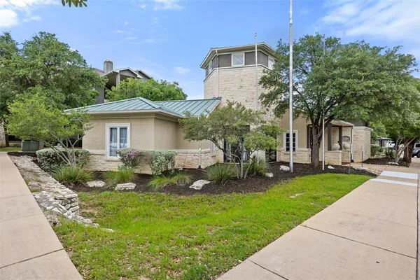 a view of a house with iron fence
