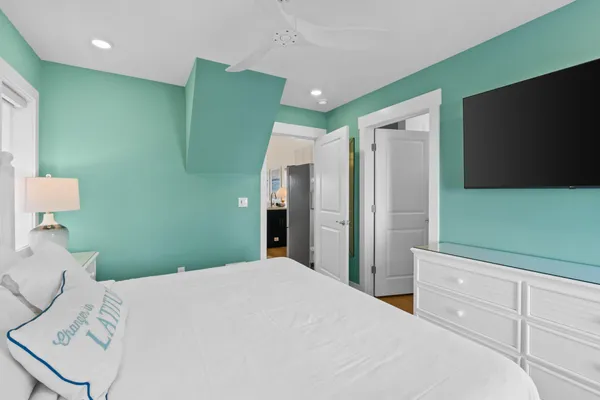 a bedroom with a bed and a flat screen tv