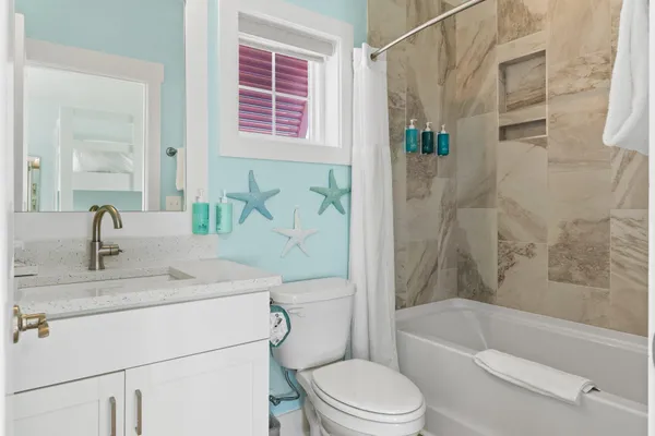 a bathroom with a sink toilet and shower