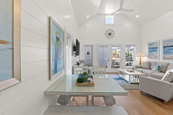 a living room with furniture kitchen and a chandelier
