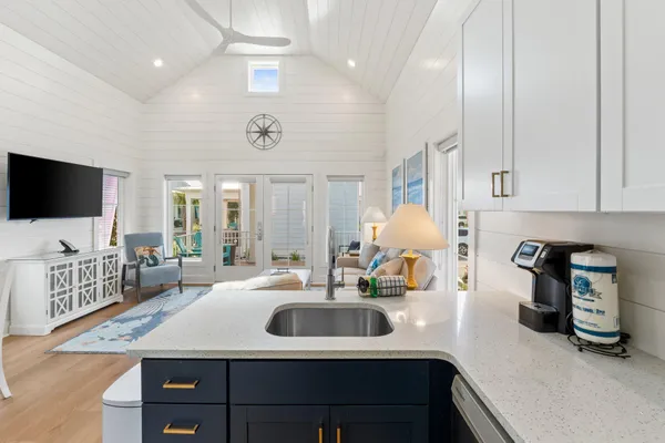 a kitchen with sink a faucet and chairs