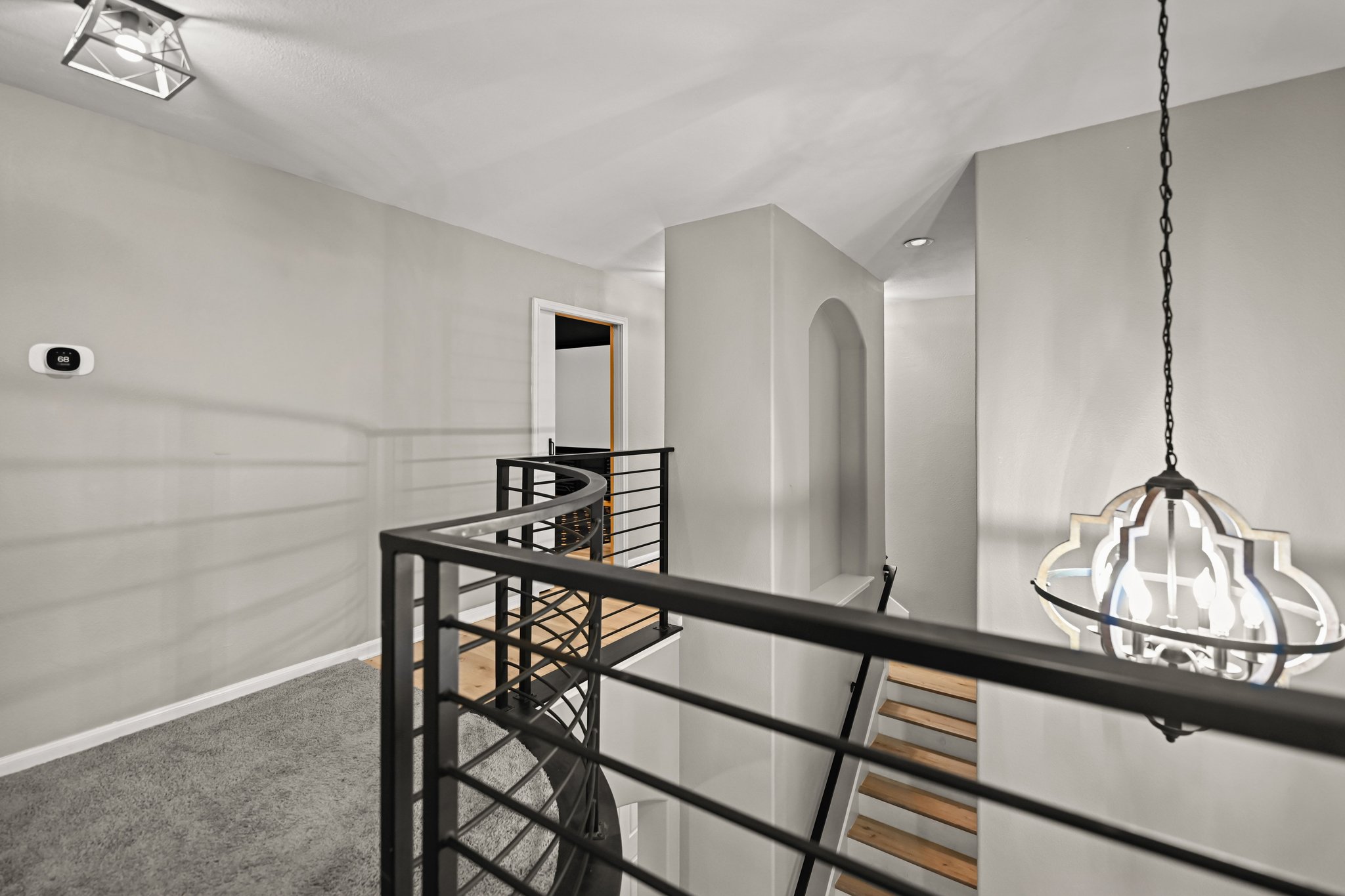 5528 Wild Foxglove Road Spicewood, TX 78669 - Photo 20 of 38 a view of a hallway with wooden floor and staircase