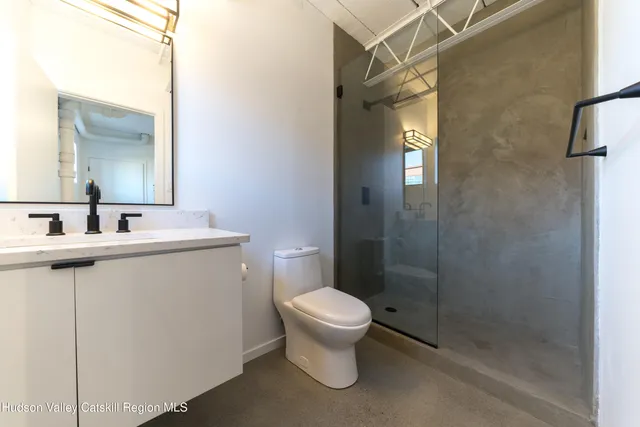 a bathroom with a toilet sink and shower