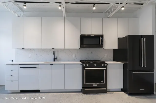 a kitchen with a refrigerator stove and microwave