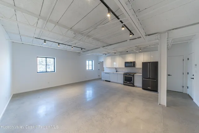 a view of a livingroom with furniture and windows