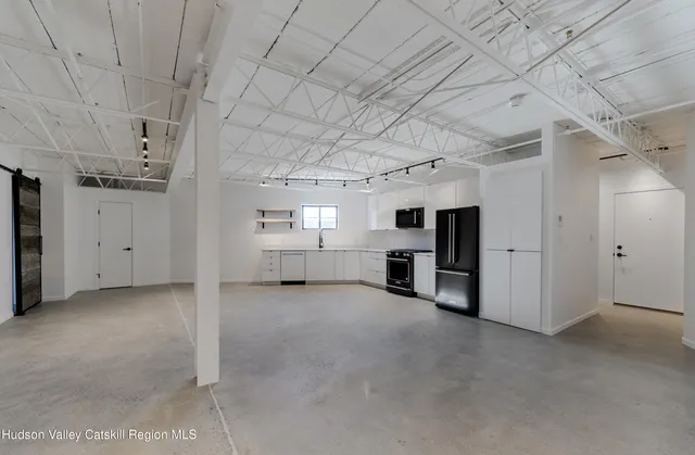 a view of empty room with white walls