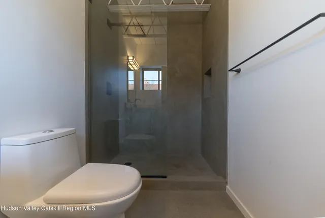 a bathroom with a toilet and a shower
