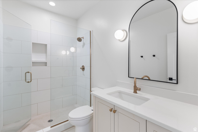 1192 East Corral Way Washington, UT 84780 - Photo 49 of 81 Contemporary bathroom featuring a frameless glass shower enclosure with white subway tile, a recessed shower niche, and a bronze shower head