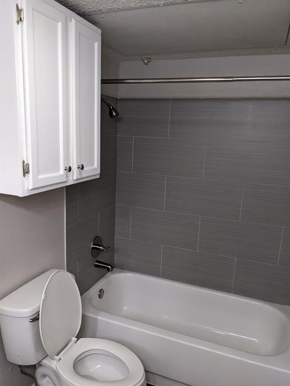 6108 Abrams Road, Unit 325 Dallas, TX 75231 - Photo 11 of 13 a bathroom with a toilet and a bathtub