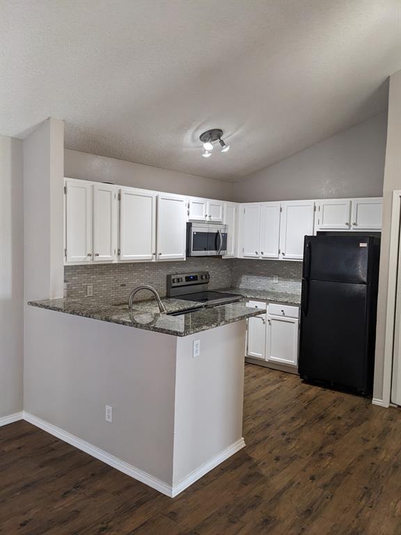 6108 Abrams Road, Unit 325 Dallas, TX 75231 - Photo 2 of 13 a kitchen with stainless steel appliances granite countertop a refrigerator and a stove top oven