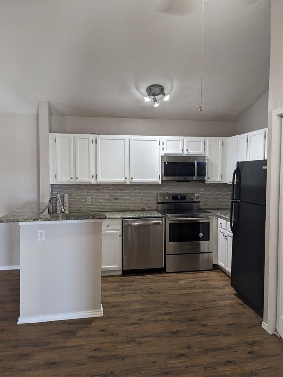6108 Abrams Road, Unit 325 Dallas, TX 75231 - Photo 3 of 13 a kitchen with granite countertop a refrigerator and a stove top oven