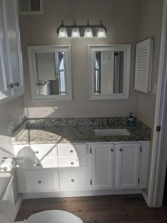 6108 Abrams Road, Unit 325 Dallas, TX 75231 - Photo 6 of 13 a bathroom with a sink and a mirror